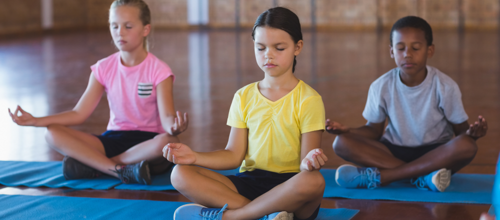 a group of youth take a youth yoga class
