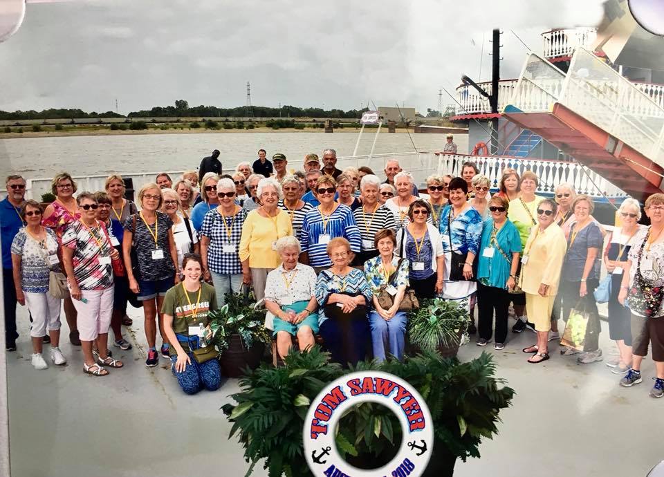 A group of active older adults on a boat during a Monroe County YMCA trip