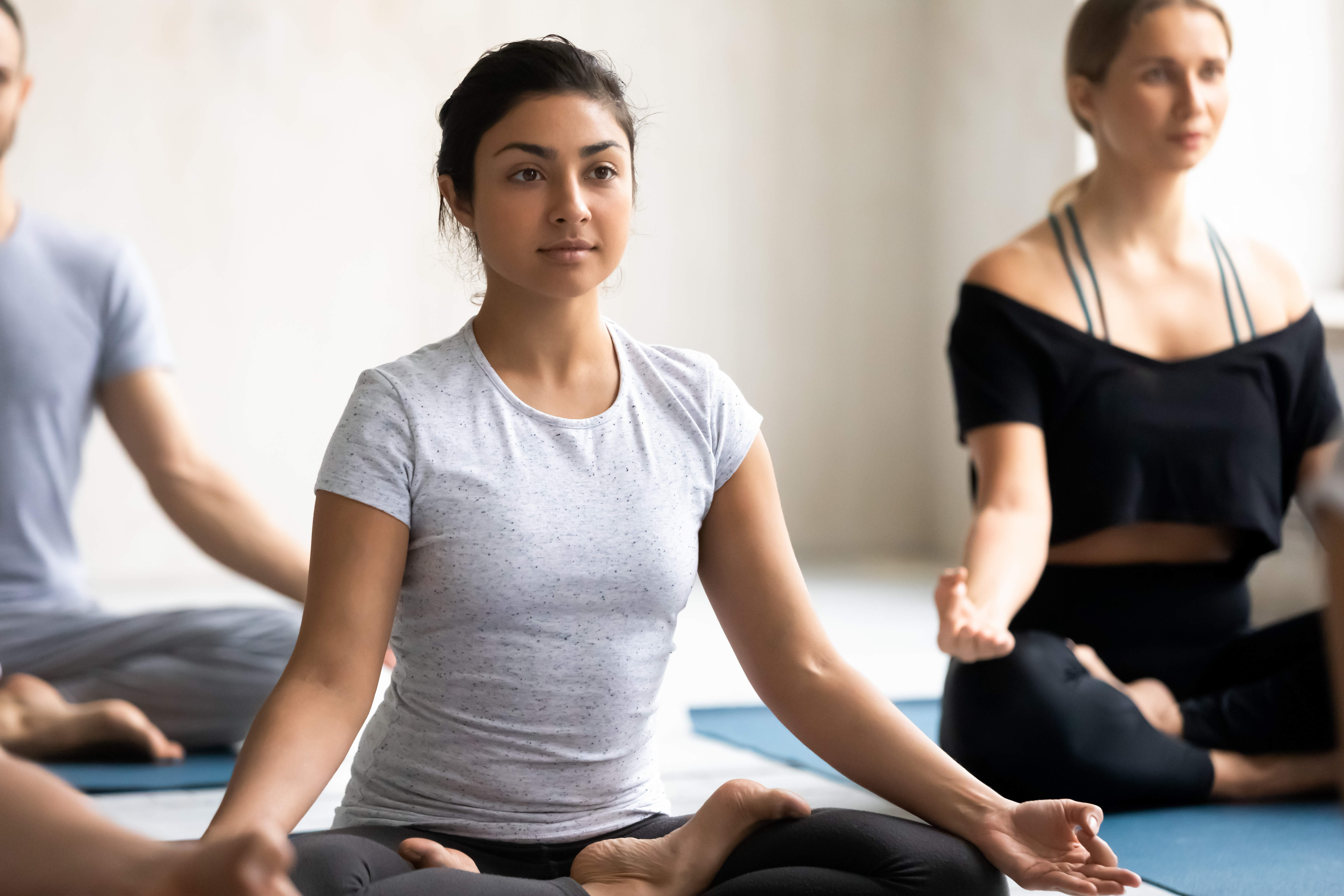 woman practicing meditation in a yoga class for her mental health