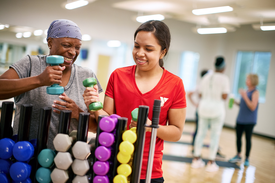 an older woman taking a ymca group exercise class