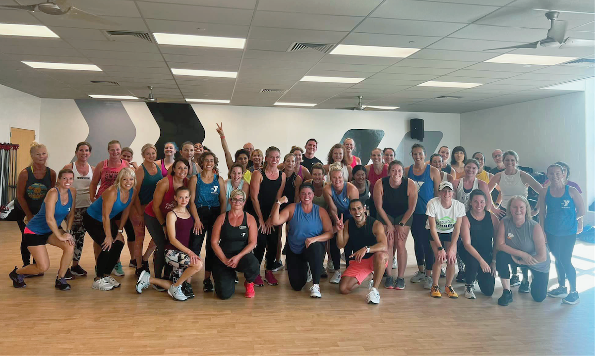 ymca group exercise participants and friends celebrating completing a zumba class