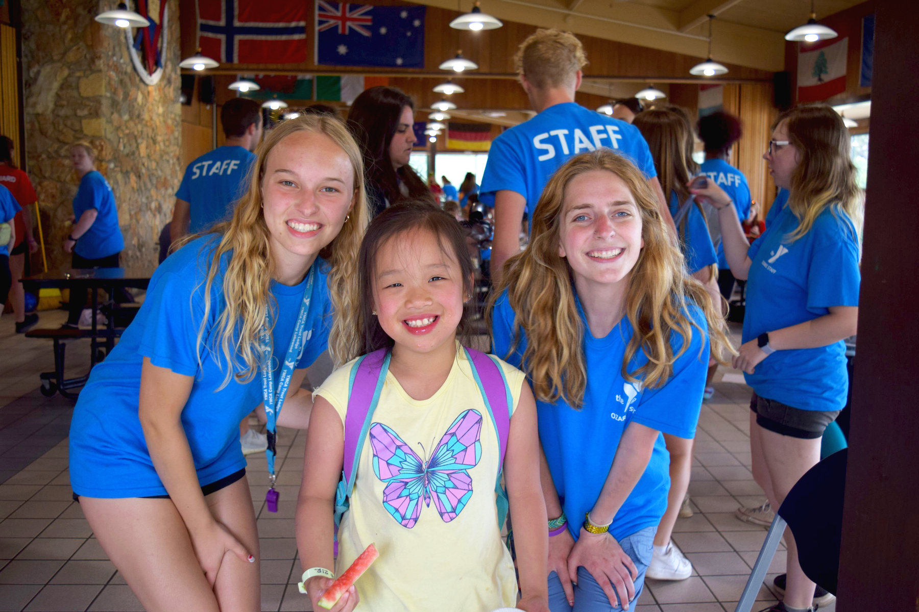 ymca camp lakewood camper with two counselors smiling