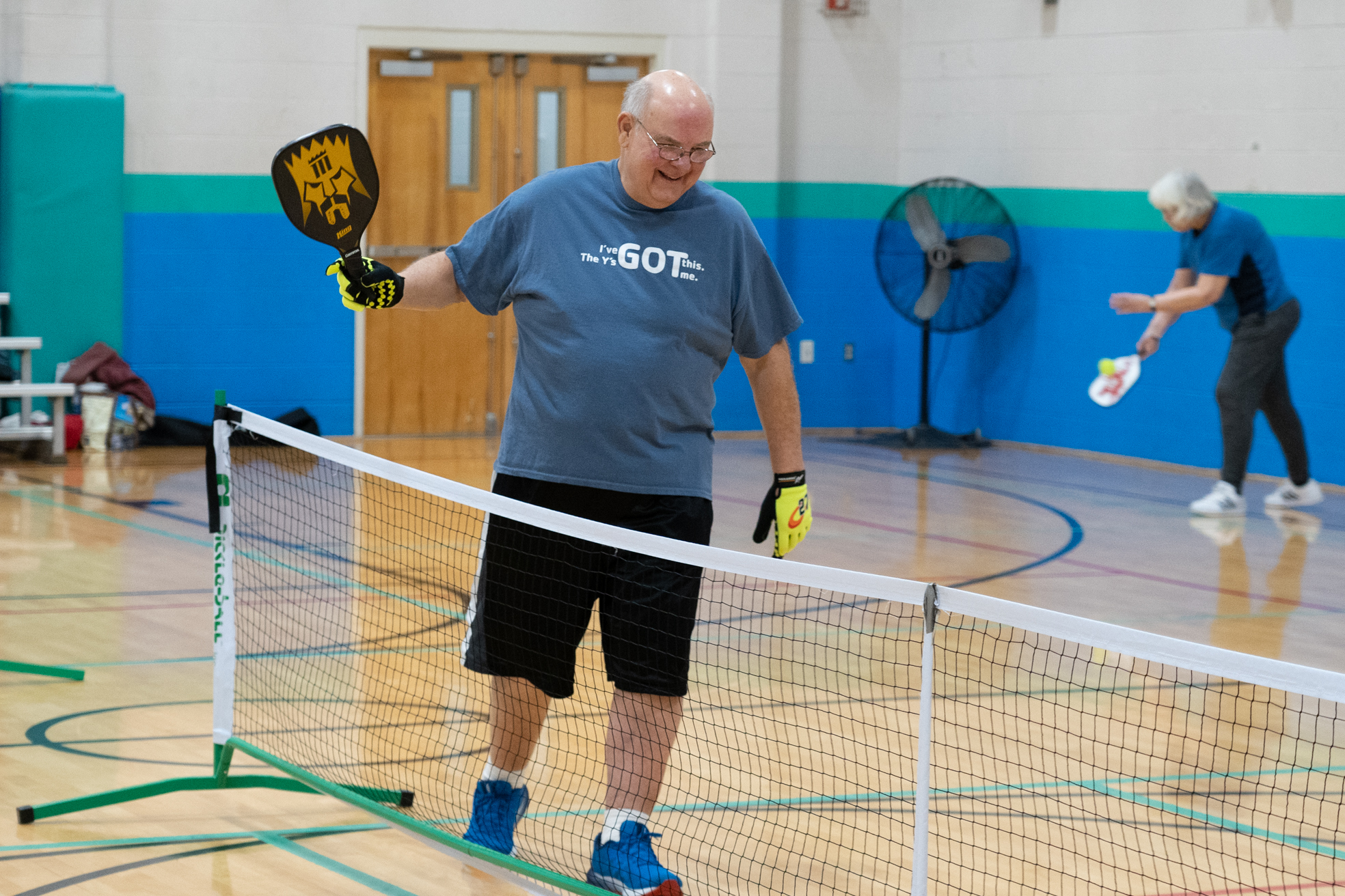 man smiling while playing pickleball at the gateway region ymca