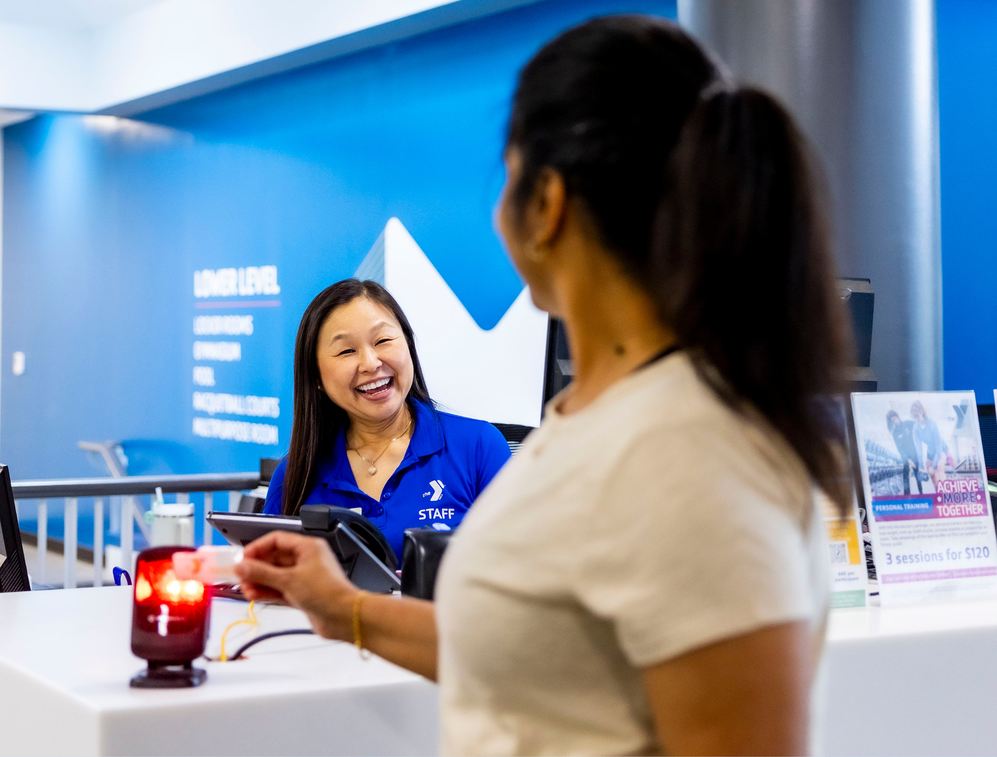 YMCA member checking in at the YMCA front desk being used as a blog image focused on gym anxiety