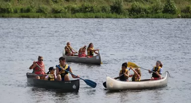 three canoes of families out on the lake