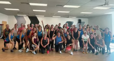 ymca group exercise participants and friends celebrating completing a zumba class