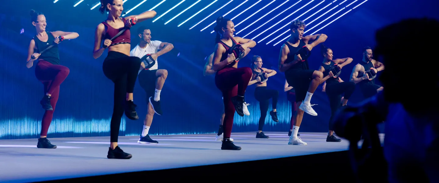 LES MILLS CORE instructors leading workout with weights