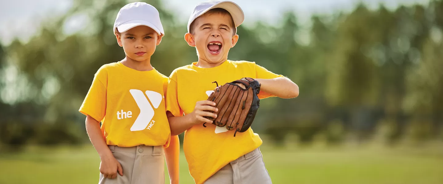 two young boys playing baseball at the ymca