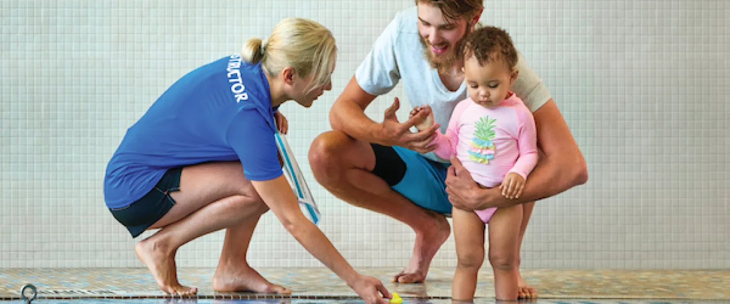 YMCA Household members, dad and daughter, taking a parent and child swimming lesson