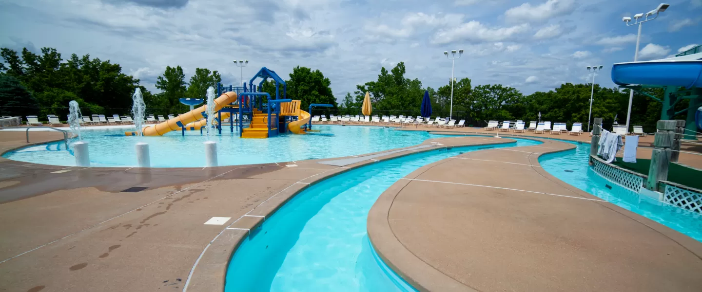 RiverChase YMCA Gym Fenton, MO Outdoor Aquatic Center featuring the lazy river, splash pad, and water playground kiddie play structure.