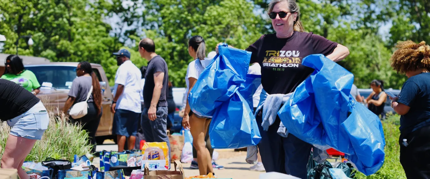 Volunteers sorting and organizing donated food items at the O'Fallon Park Rec Complex YMCA relief center