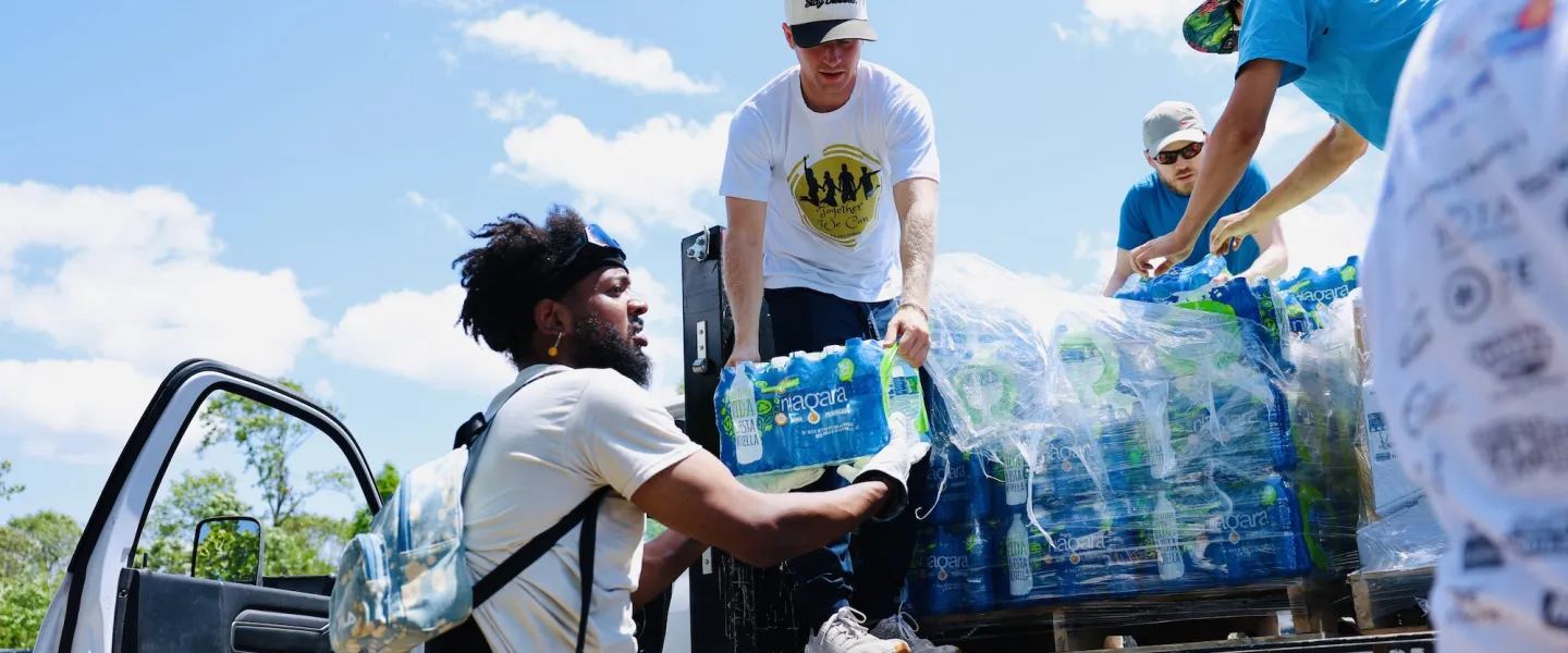 YMCA tornado relief volunteer unloading cases of bottled water from a supply truck at O'Fallon Park Rec Complex