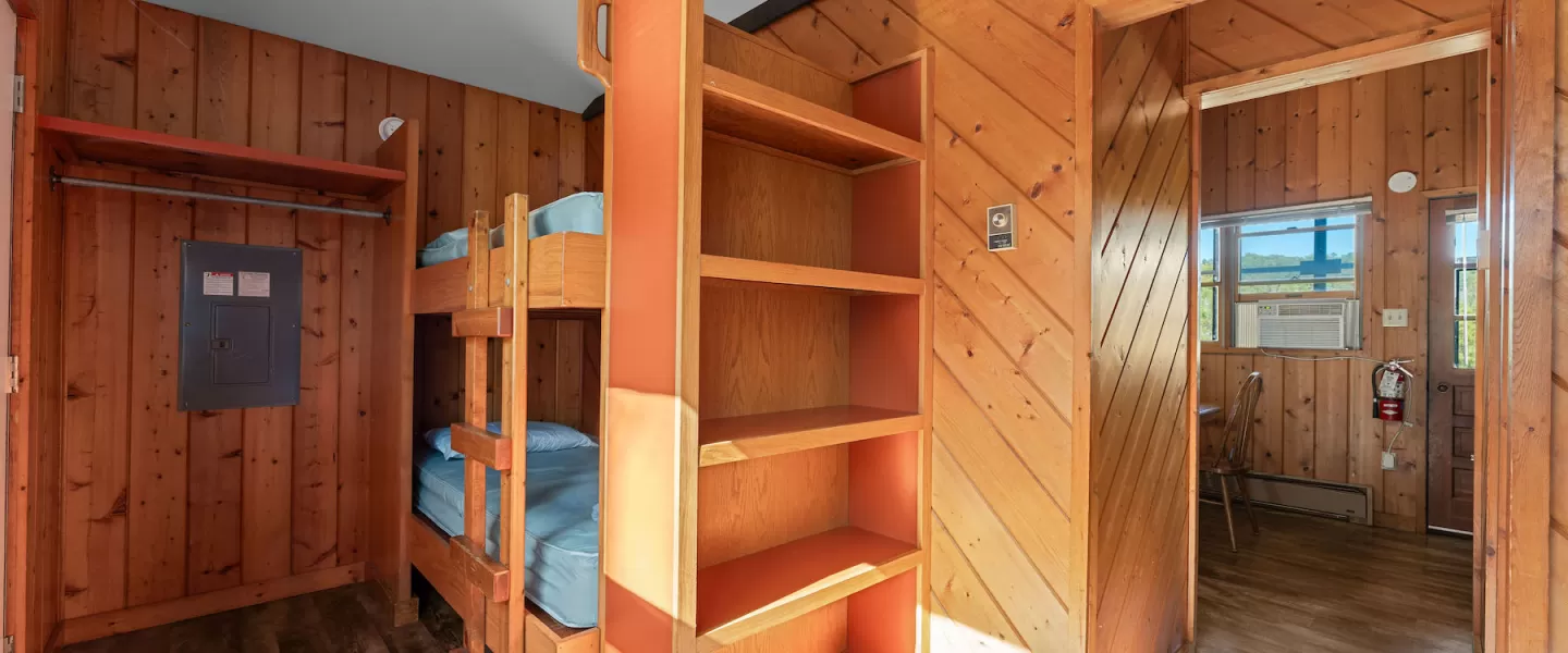 Spacious bunk room with two twin bunk beds and natural light from cabin windows