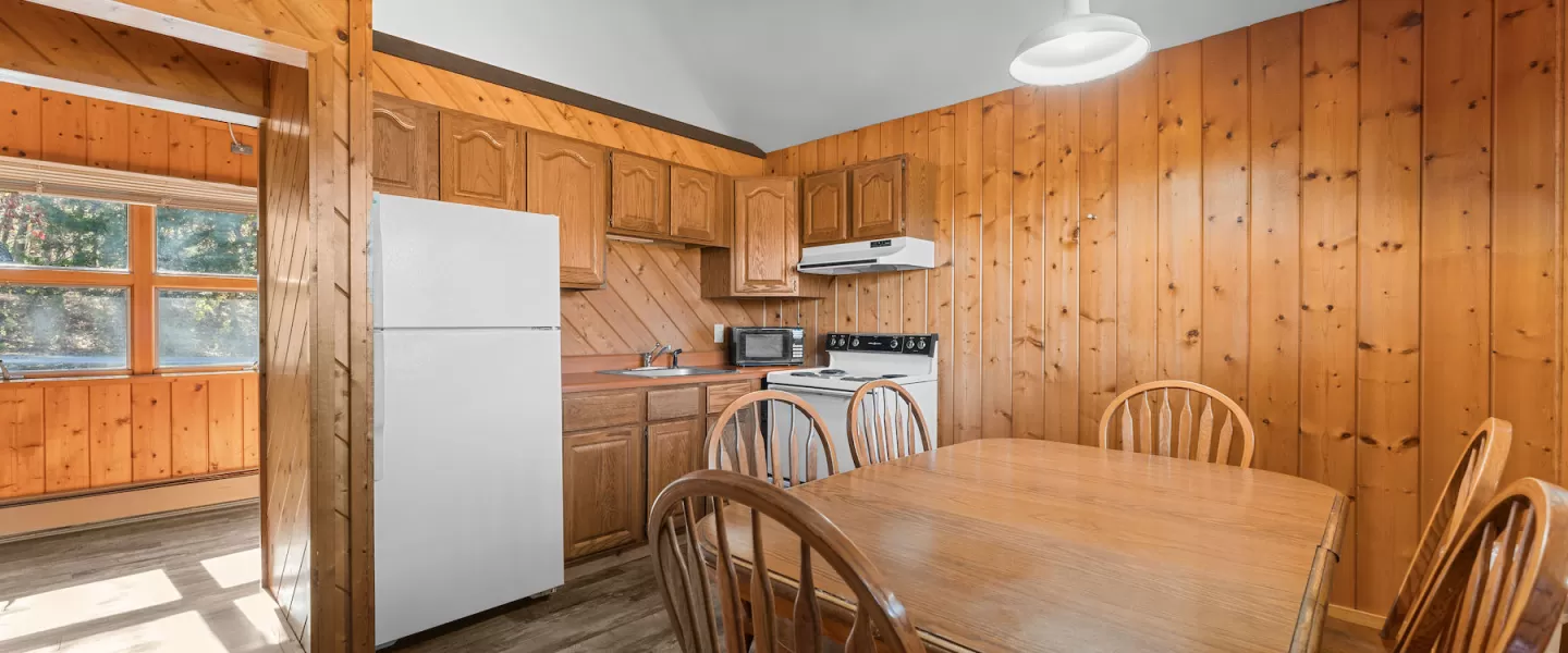 Open-concept Bluff View Cabin with kitchenette and dining table in shared space near bunk rooms