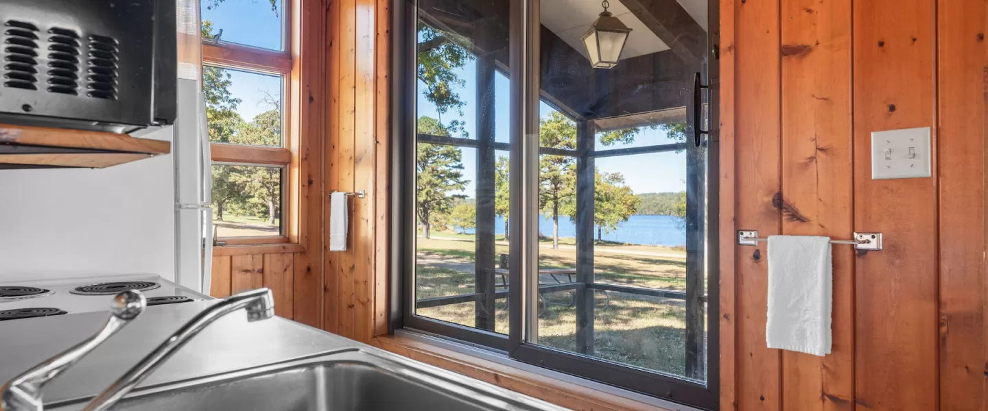 Fully equipped Bluff View Cabin kitchen with stove, refrigerator, microwave, and sink for guest convenience
