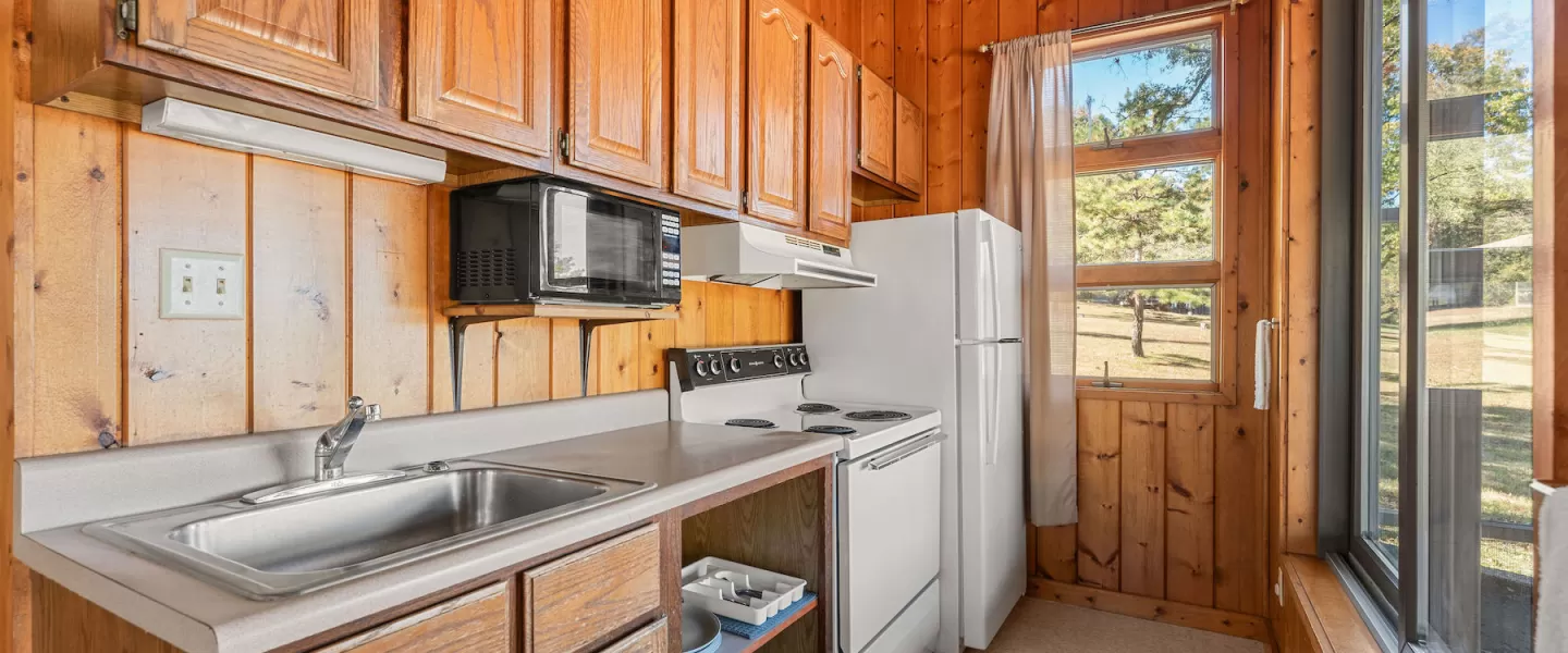 Compact kitchenette view with cooking appliances and counter space
