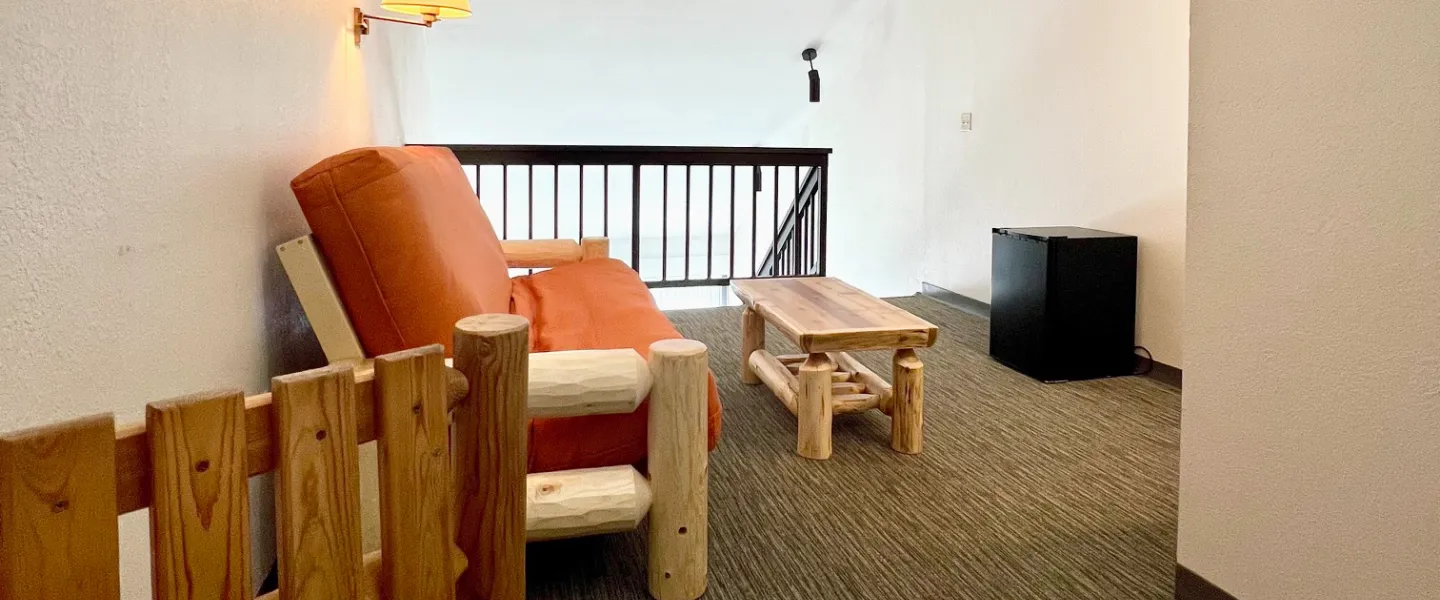 Cozy sitting area in Loft Room with table and chairs, sofa, and coffee table