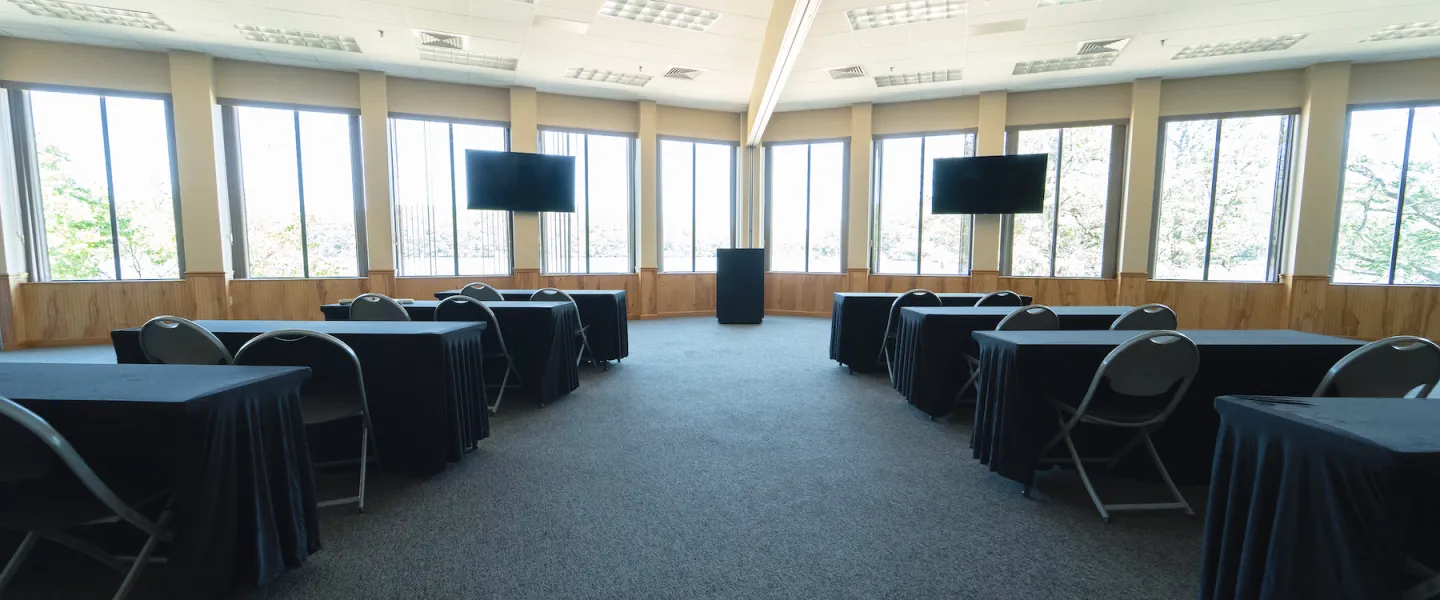 Meeting room setup with projector and tables for corporate retreat