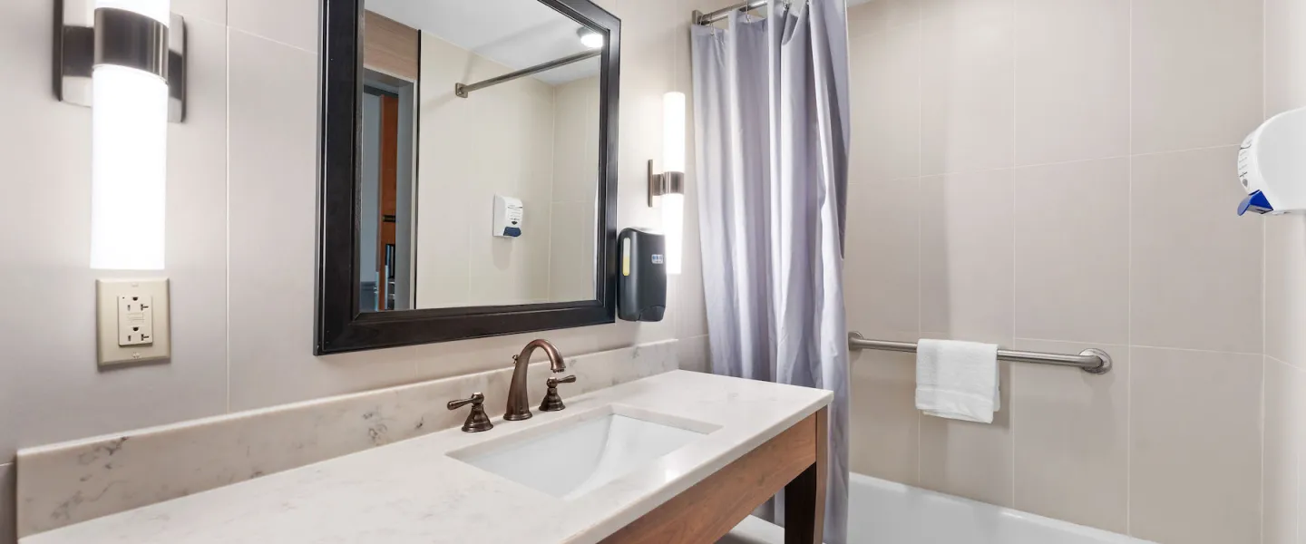 Lodge Room bathroom with bathtub-shower combo and clean modern finishes