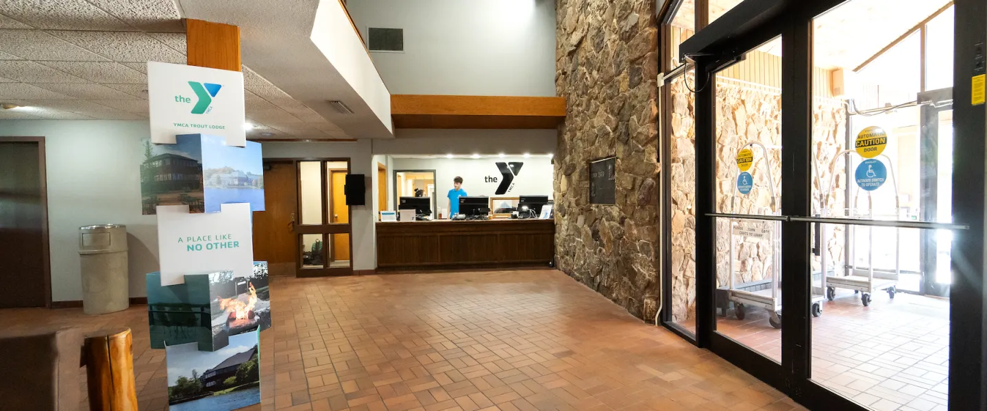 Main lobby with vaulted ceilings, fireplace, and guest seating area