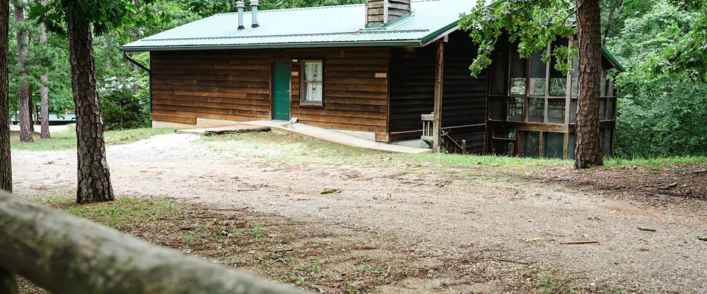 Exterior view of a Forest View Cabin tucked in the trees within the Ozark hills on YMCA Trout Lodge's Potosi, MO campus.