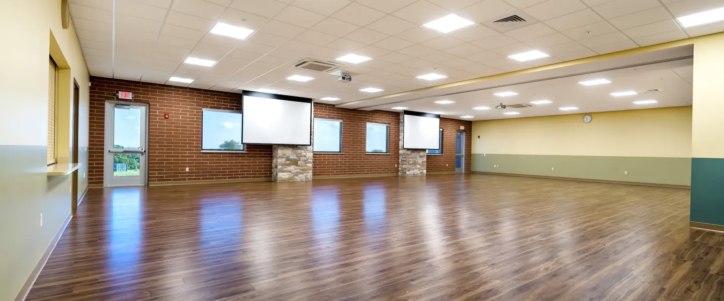 Ste. Genevieve County YMCA Meeting Room with projector screens for work events, conferences, showers, and gatherings. 
