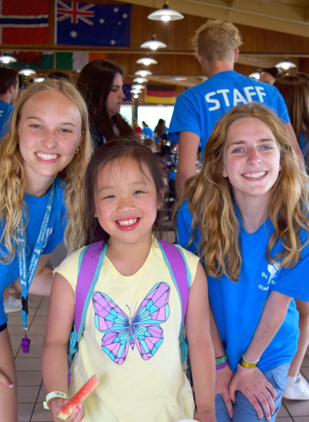 ymca camp lakewood camper with two counselors smiling