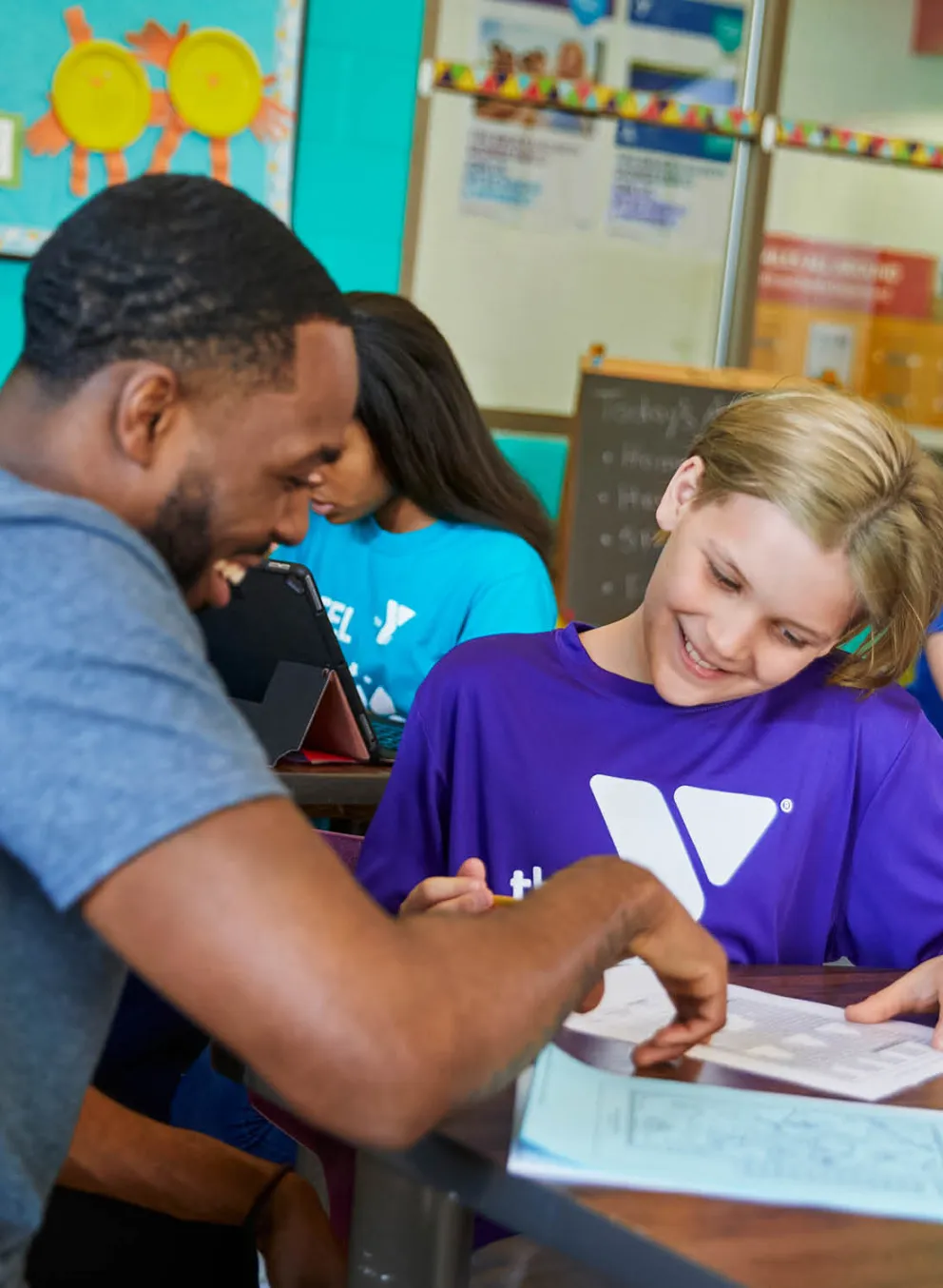 ymca staff teaching student enrolled in summer school y club