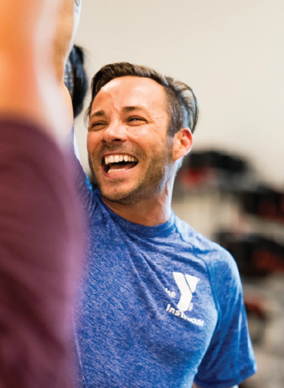 ymca group exercise instructor cheering on his group exercise class participants