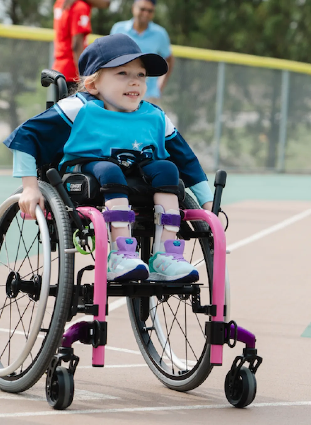 young girl in wheelchair playing adaptive baseball at the ymca with all star game logo