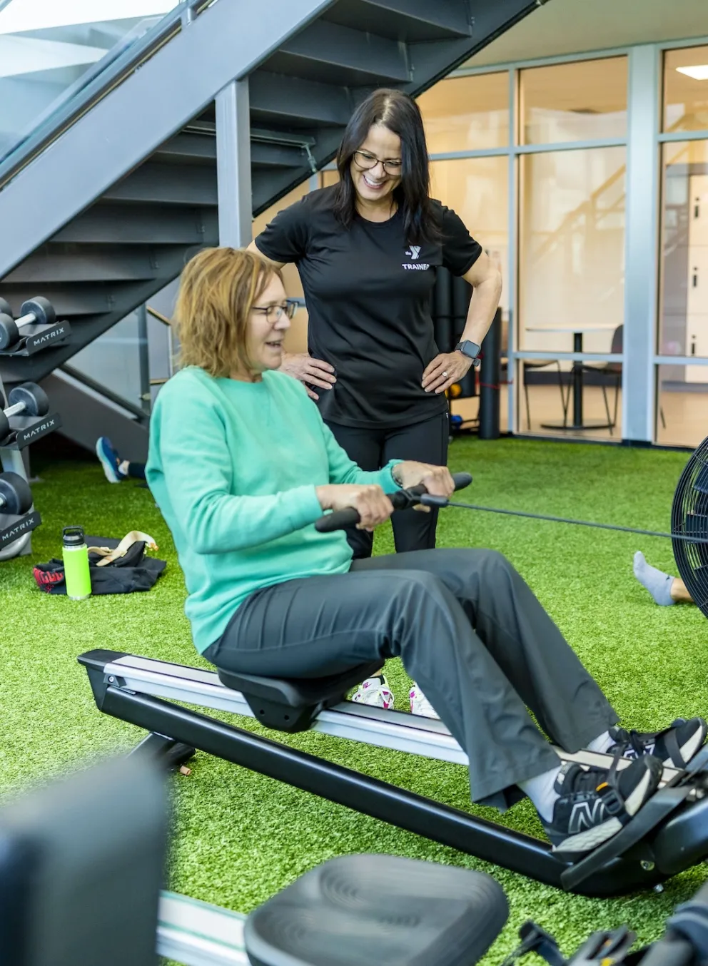 trainer giving a fitness orientation at the ymca