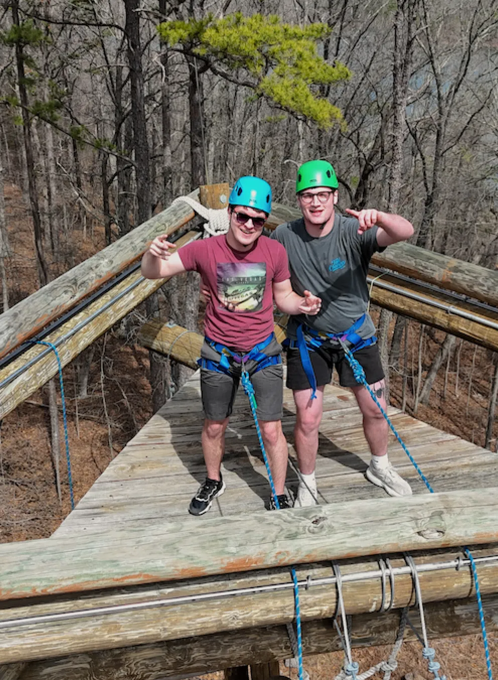 Two colleagues climbing to the top of the YMCA Trout Lodge Alpine Tower as part of an IMPACT Team-Building Program activity.
