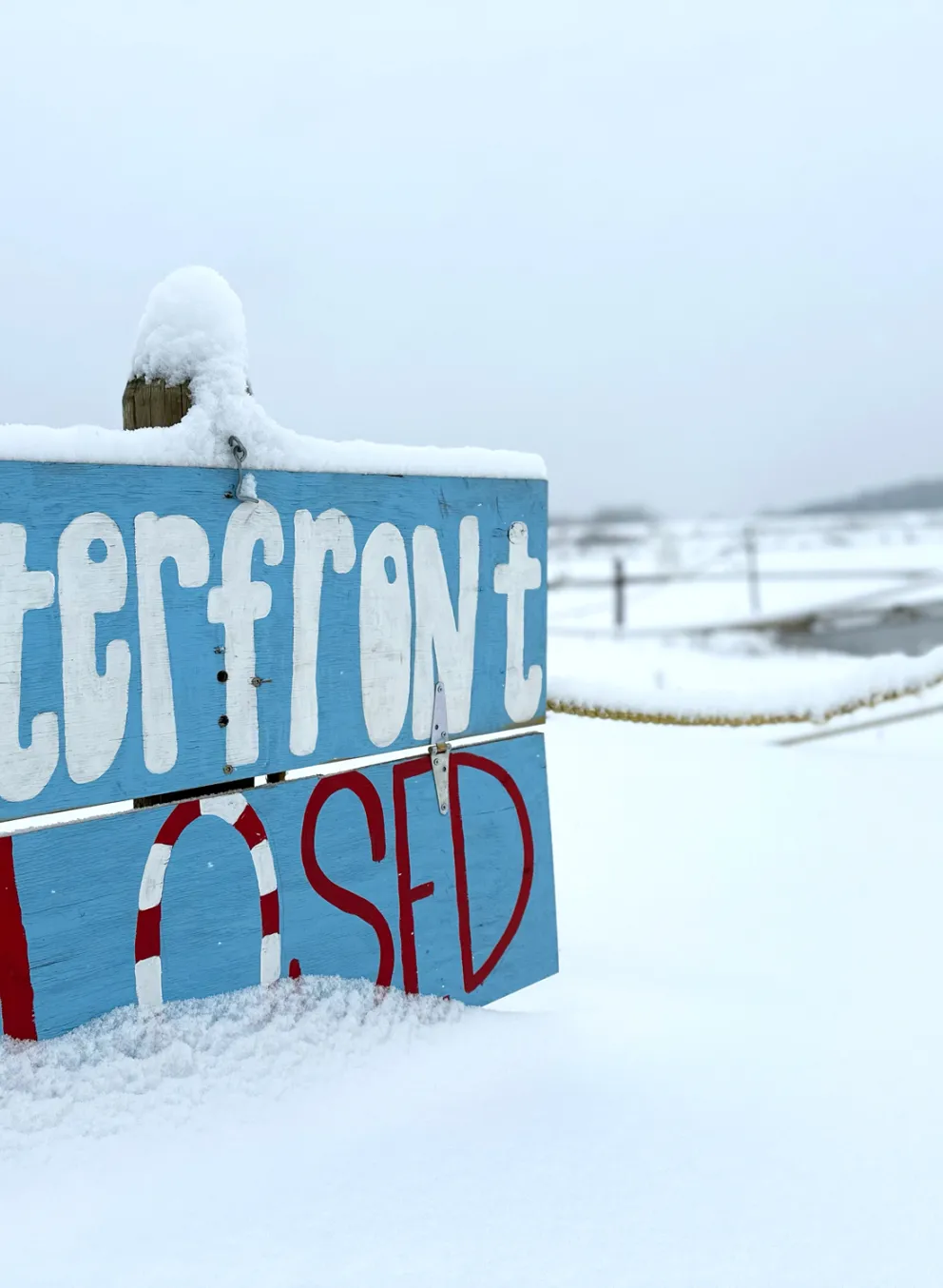 YMCA Trout Lodge Waterfront Closed Sign covered in Winter snow
