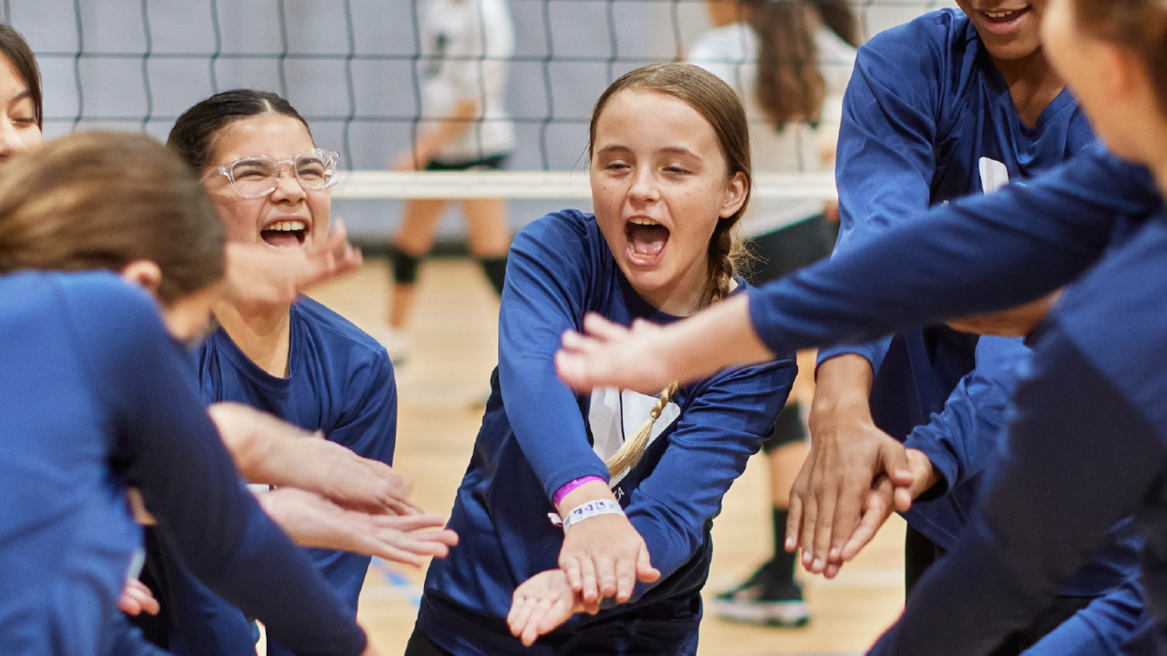 ymca youth volleyball team doing a chant