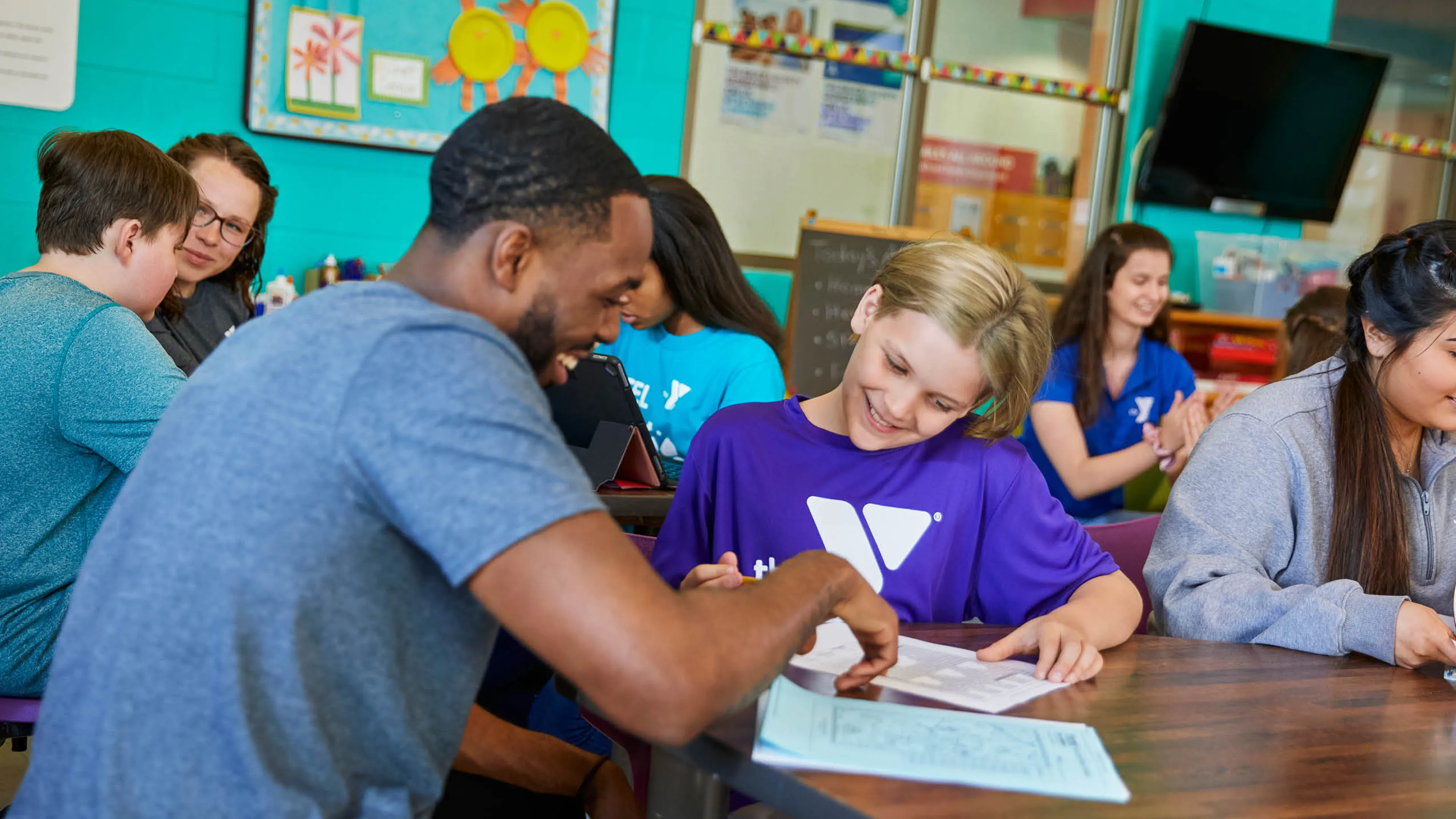 ymca staff teaching student enrolled in summer school y club