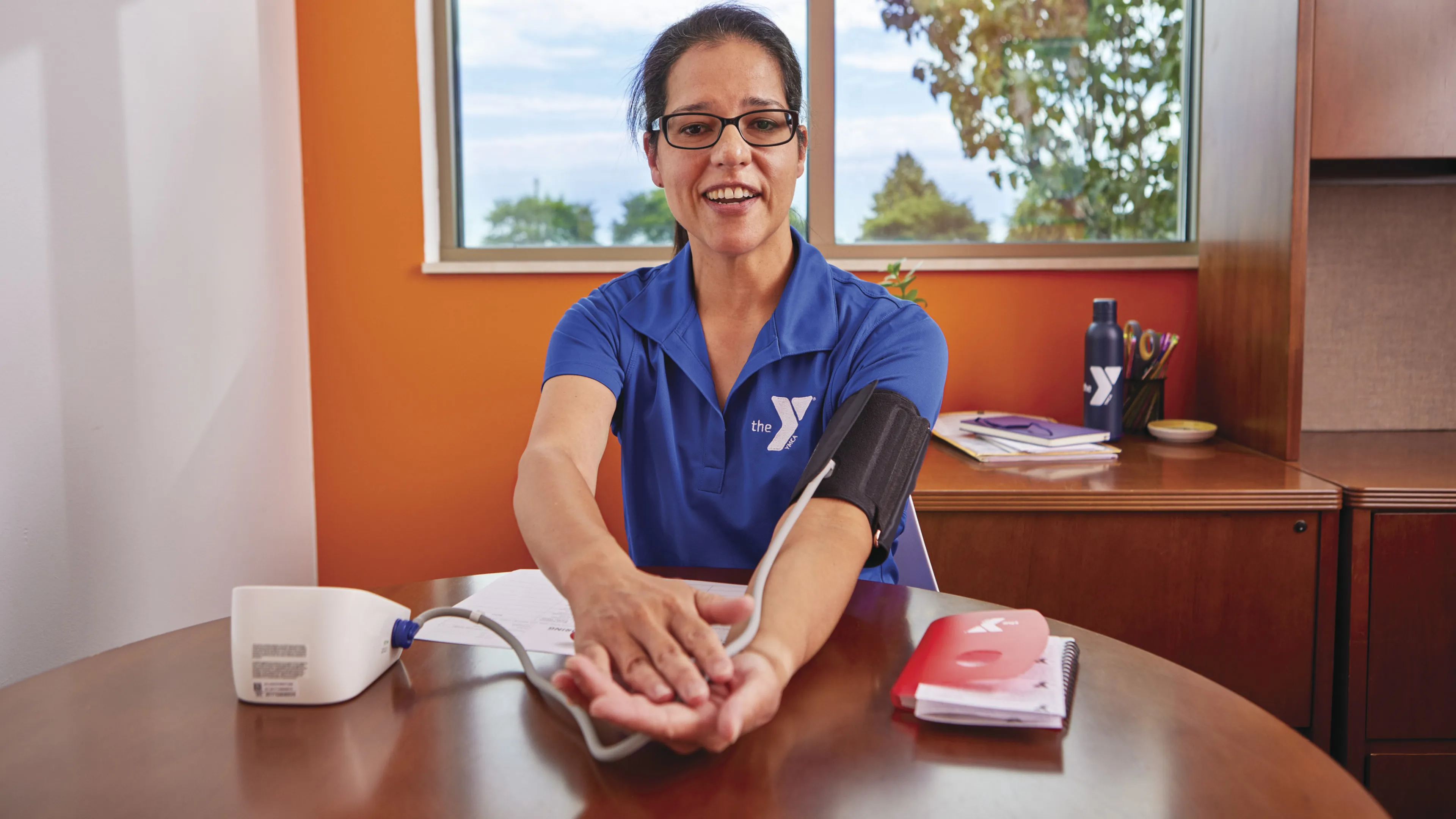 woman at the YMCA checking her blood pressure