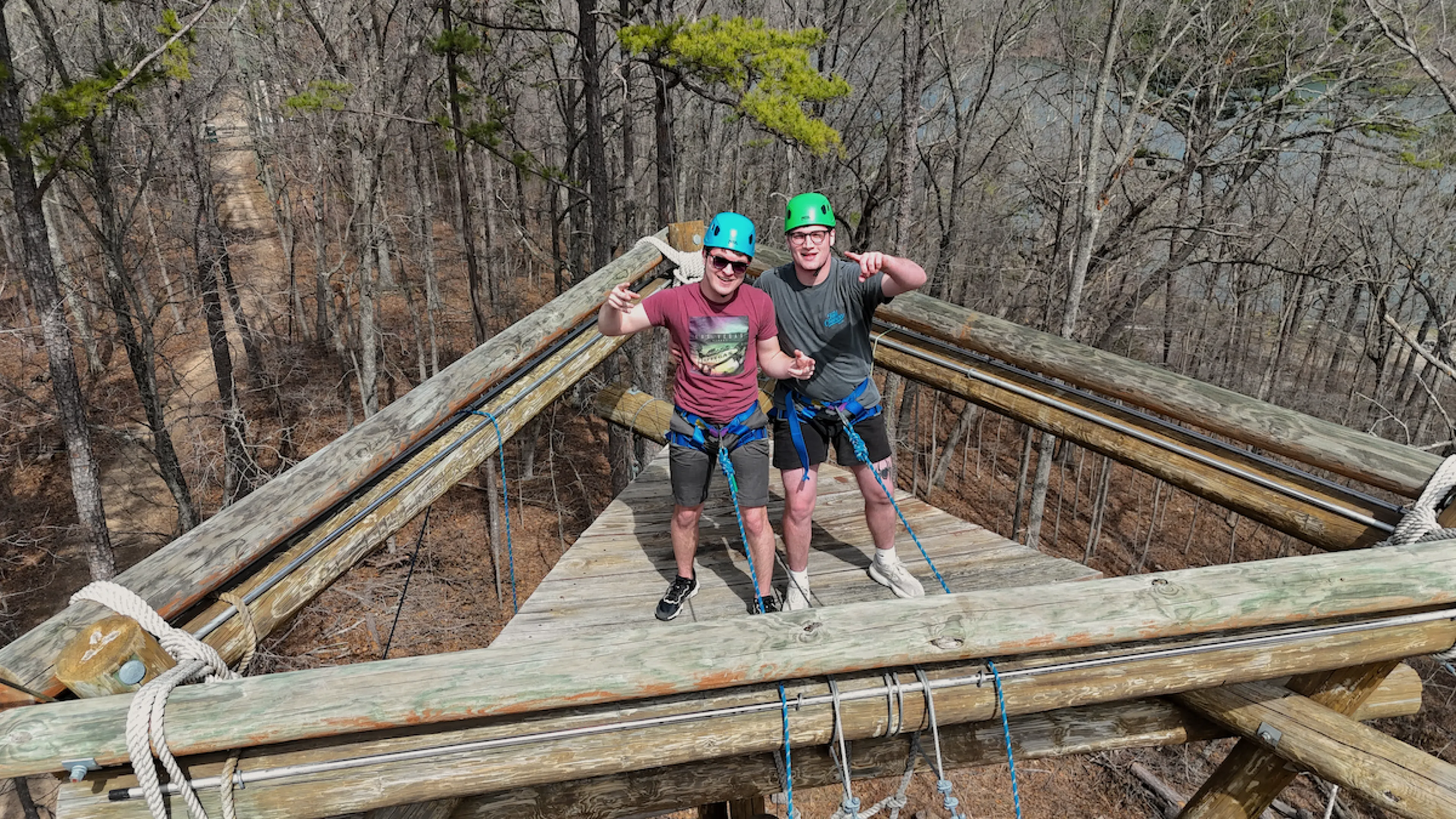 Two colleagues climbing to the top of the YMCA Trout Lodge Alpine Tower as part of an IMPACT Team-Building Program activity.