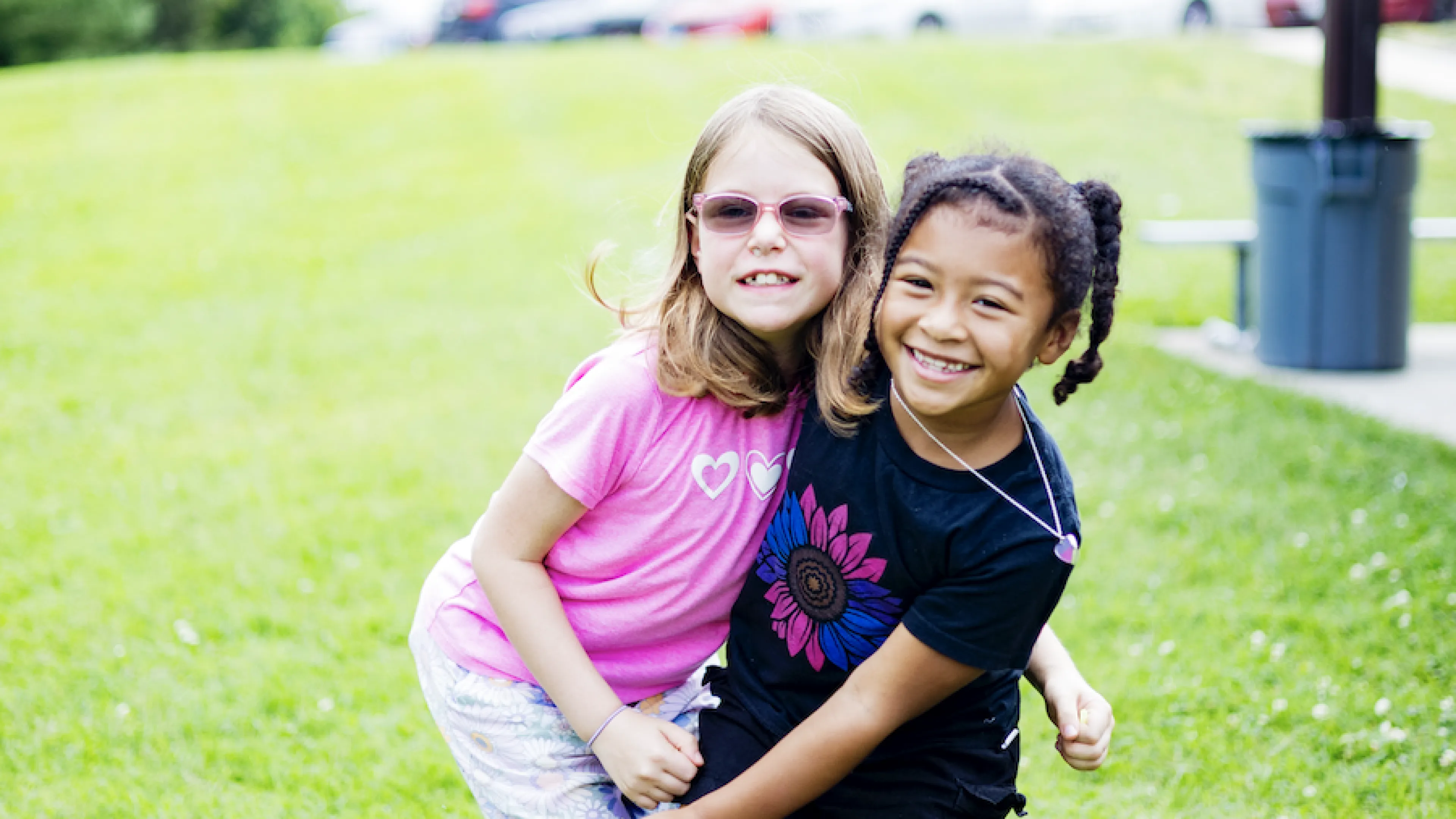 two girls hugging at YMCA summer day camp