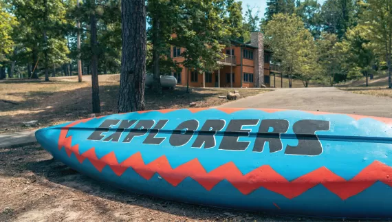 ymca camp lakewood explorers canoe in front of main camp cabin