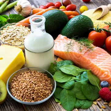 nuts, fish, cheese, vegetables on a table