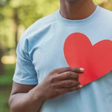 man holding a heart to his chest