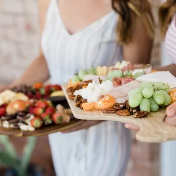 girls holding charcuterie plates