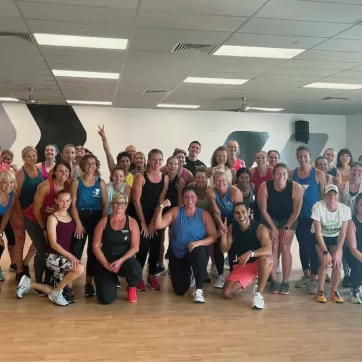 ymca group exercise participants and friends celebrating completing a zumba class