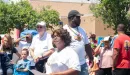 Thumbnail: An image taken of the diverse group of men, women, and children taken at the YMCA's backpack give-away.