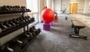 Thumbnail: Dumbbells and stretching area. Medicine balls also along wall.