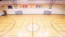 Thumbnail: One-court gymnasium with 6 basketball hoops. Indoor track running overhead.