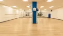 Thumbnail: Group exercise room with mirrors on one side. Large, rectangular room with non-slip flooring.