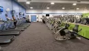 Thumbnail: Cardio room with rows of treadmills, ellipticals, and stationary bikes. Windows on all sides of room.