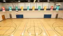 Thumbnail: Gymnasium with multiple hoops. Indoor track running overhead. Lines for basketball, volleyball, and pickleball.