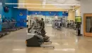 Thumbnail: Cardio space with treadmills, ellipticals, and zero-impact trainers. Spacious rows in between equipment.